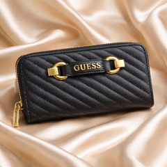 Guess Sela SLG large zip-around wallet in black quilted pebble polyurethane with gold-tone hardware.