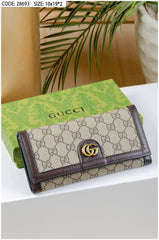 Gucci Ophidia chain wallet in beige and dark brown GG supreme canvas with the gold-toned Double G hardware.