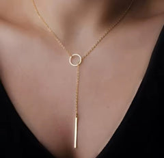 This product appears to be a minimal gold-plated lariat necklace featuring a circle and a vertical bar