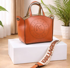 Karl Lagerfeld K/Circle perforated leather tote bag in Sudan Brown or Dark Tan.