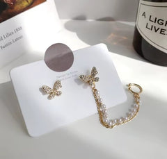 These earrings are described as Butterfly Pearl Earcuff Tassel Earrings, featuring a rhinestone-adorned butterfly stud connected to a cascading pearl chain ear cuff.