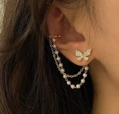 These earrings are described as Butterfly Pearl Earcuff Tassel Earrings, featuring a rhinestone-adorned butterfly stud connected to a cascading pearl chain ear cuff.