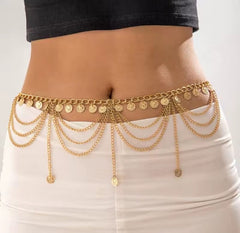 a gold-colored, multi-layered metal belly chain with small ball or coin pendants.