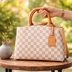 Louis Vuitton Damier Azur canvas bag with a brown leather trim.