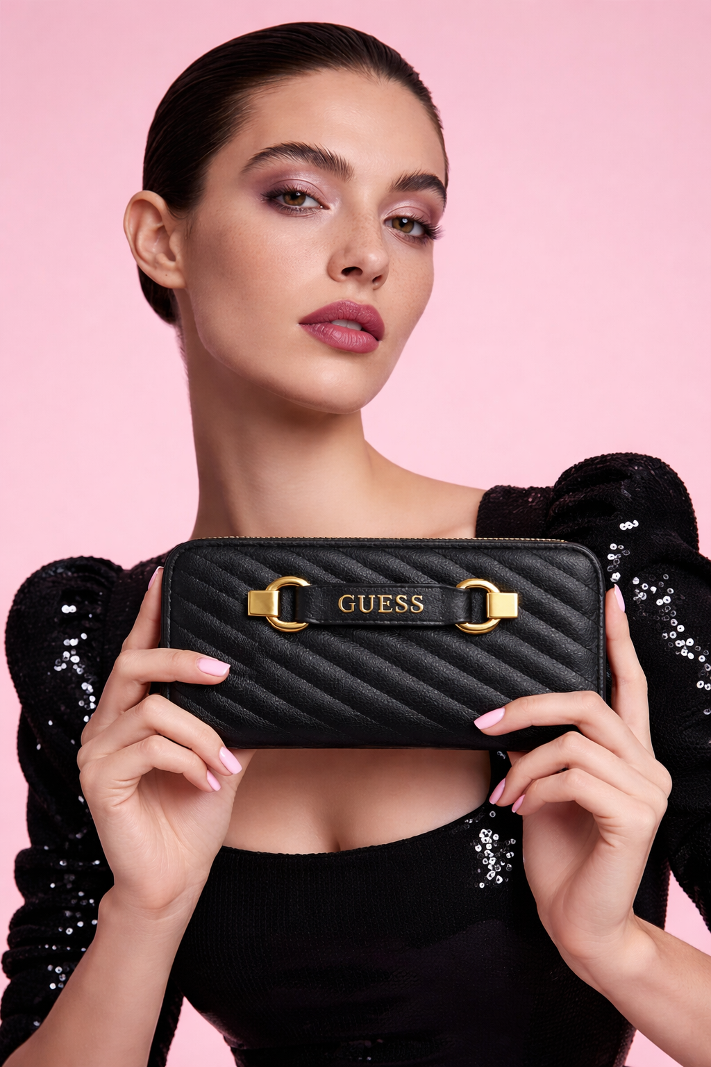 Guess Sela SLG large zip-around wallet in black quilted pebble polyurethane with gold-tone hardware.