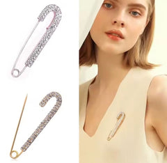 a rhinestone safety pin brooch, often featuring a robust metal base adorned with sparkling crystals.