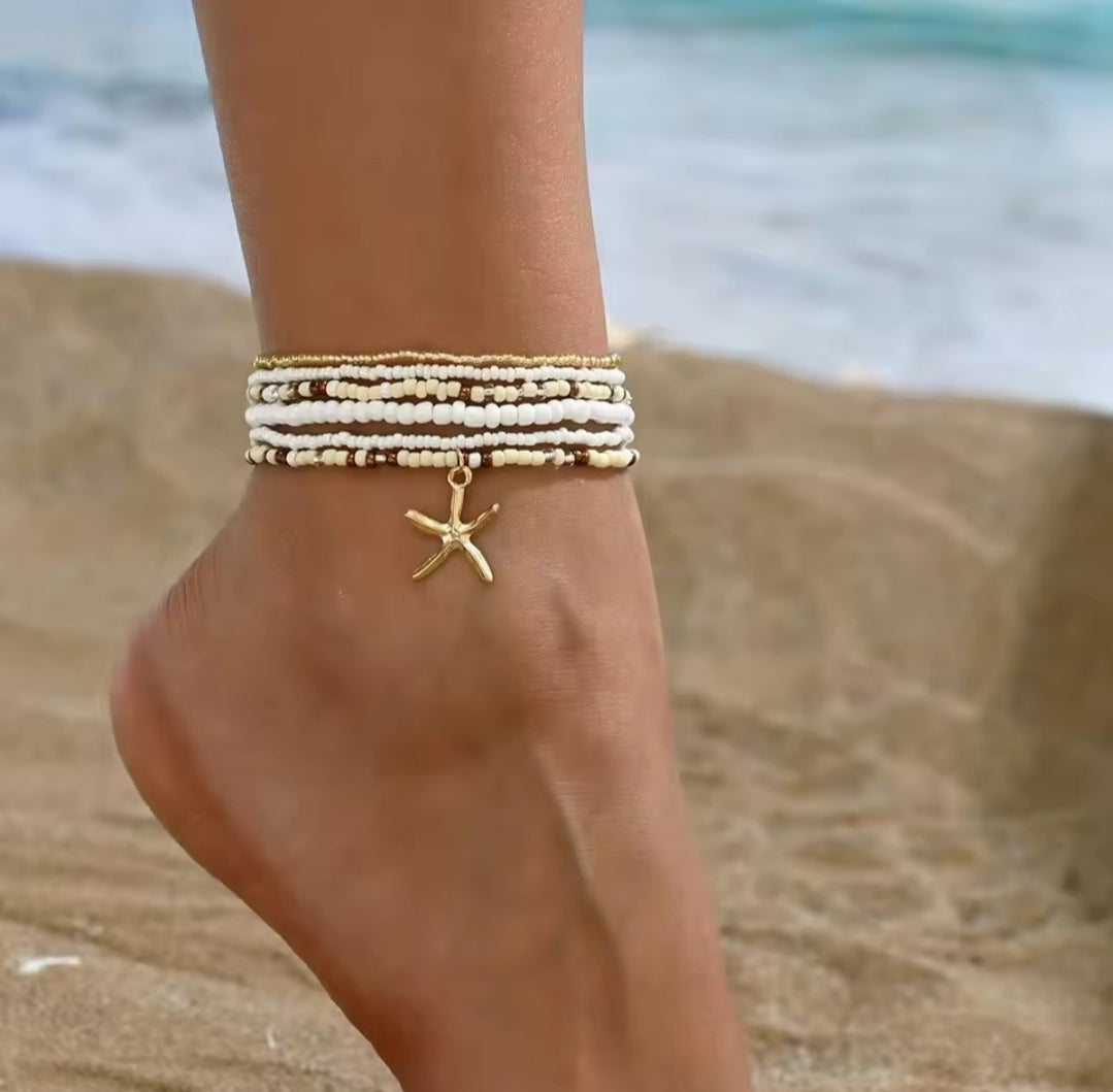 This multilayer starfish pendant anklet is a bohemian-style accessory featuring colorful beads and gold-toned starfish charms, perfect for enhancing beachwear.