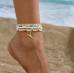 This multilayer starfish pendant anklet is a bohemian-style accessory featuring colorful beads and gold-toned starfish charms, perfect for enhancing beachwear.