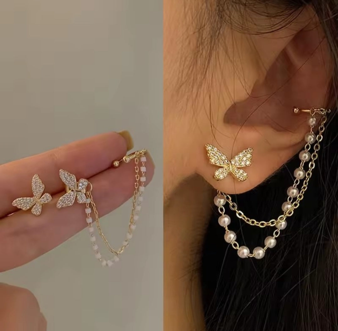 These earrings are described as Butterfly Pearl Earcuff Tassel Earrings, featuring a rhinestone-adorned butterfly stud connected to a cascading pearl chain ear cuff. 