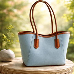 blue David Jones tote bag with brown handles and a decorative beaded charm attachment