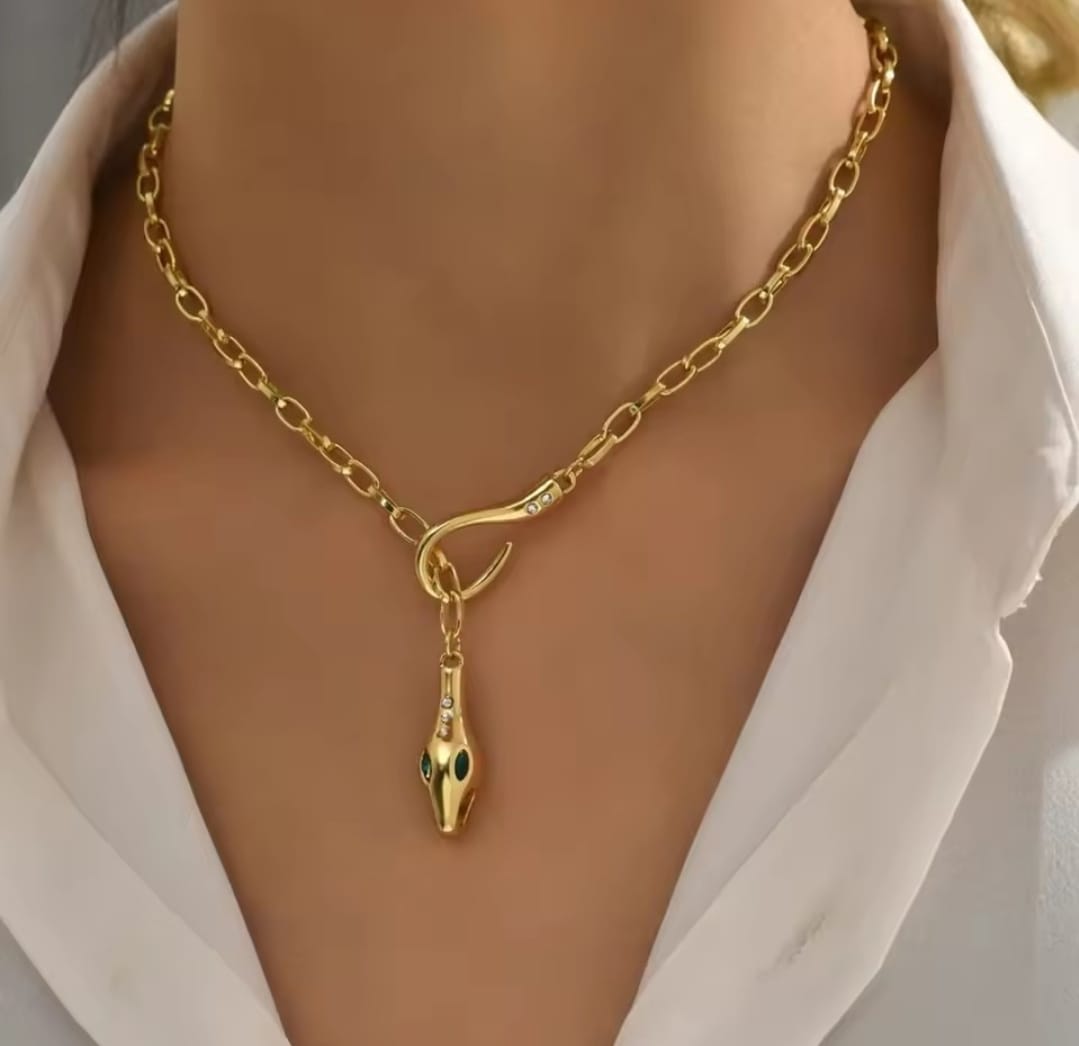 This is a gold-plated snake pendant necklace with green eyes. 